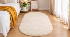 Budget Bedroom Makeover with a cozy white rug and mustard throw blanket.