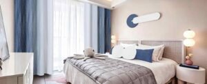 Budget Bedroom Makeover with blue curtains, cozy bedding, and modern decor.