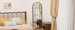 Large arched mirror in a cozy bedroom for small bedroom ideas.