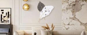 Elegant living room wall with decorative leaf clock and artwork.