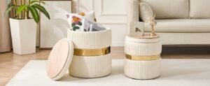Stylish living room items, including cream storage ottomans with gold accents beside a sofa.