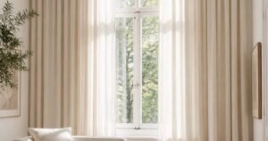 Small bedroom ideas with light curtains and a cozy neutral seating area.